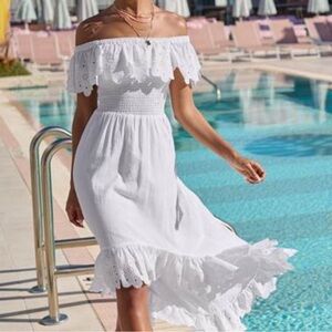 Smocked off shoulder white dress with high low hem.